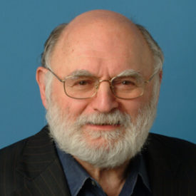 Victor Navasky professional headshot. He is an older white man with a bald head and a grey beard.