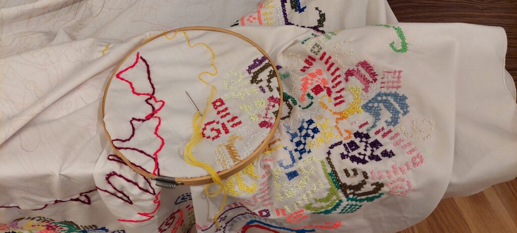 an embroidery in progress with colorful yarn